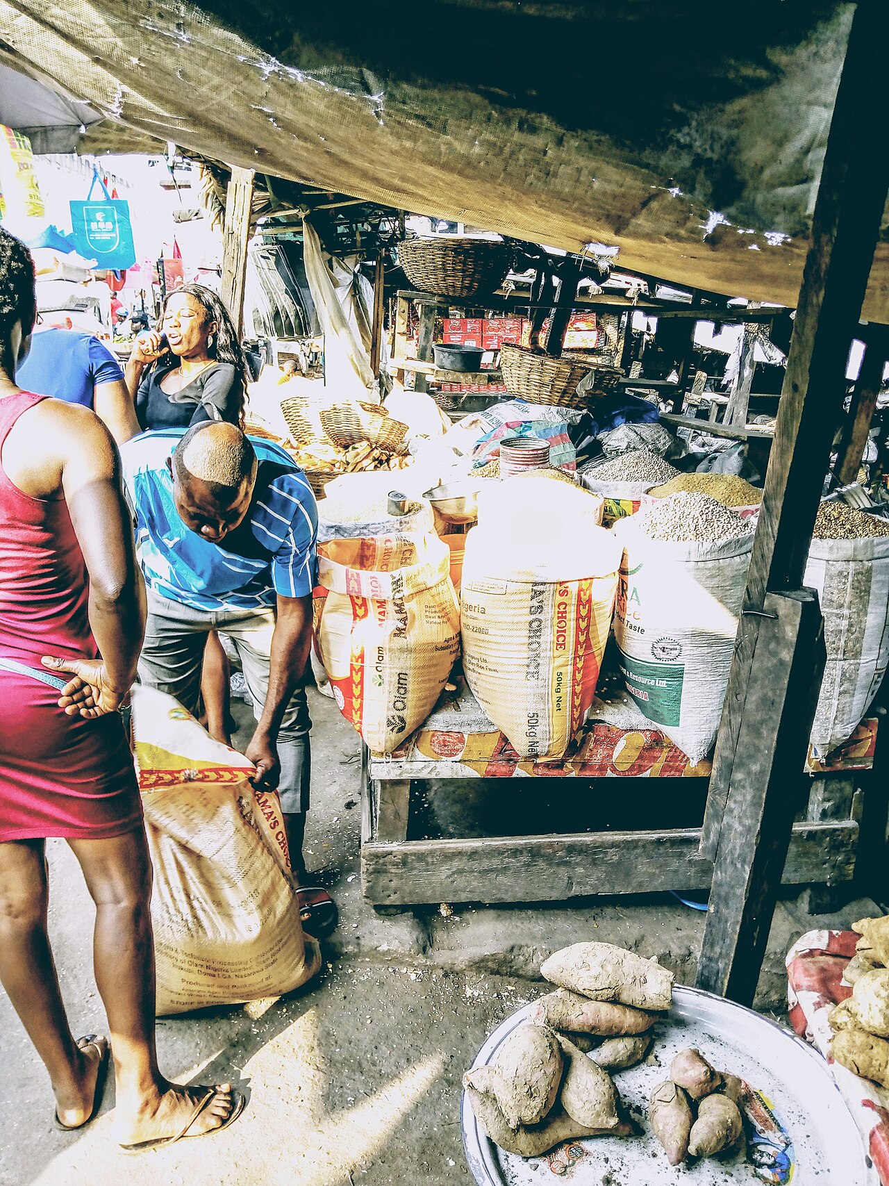 Local food sellers and buyers at an African grain market